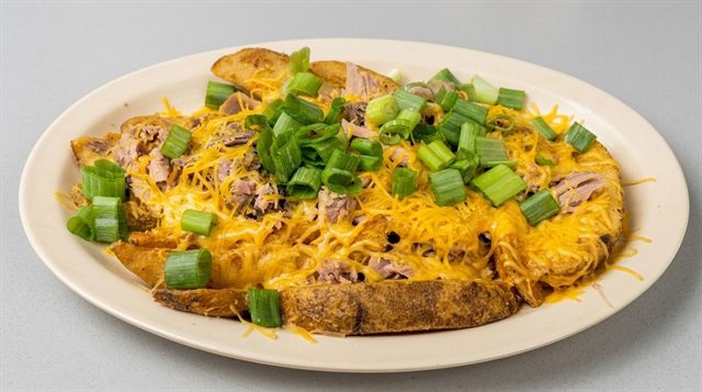 Hickory Hobo potato wedges loaded with BBQ pork, shredded cheese, and chives from Betty's Bar-B-Q in Anniston, AL