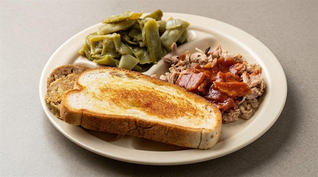 Small BBQ pork plate with green beans, fried green tomatoes, and BBQ bread at Betty's Bar-B-Q in Anniston, AL